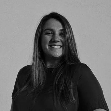 A black and white photo of Fisher EasleySmith smiling at the camera.